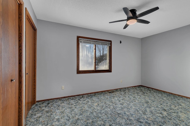 unfurnished bedroom featuring a textured ceiling, ceiling fan, carpet, and a closet