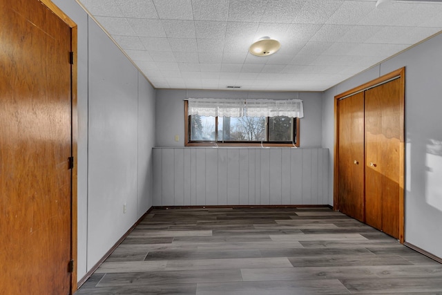 unfurnished room featuring hardwood / wood-style flooring