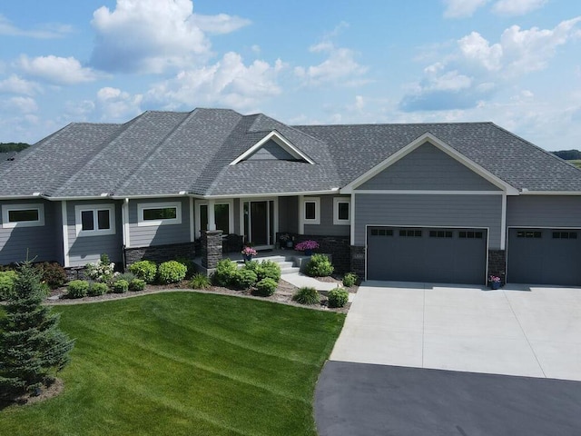 craftsman-style home featuring a front yard and a garage