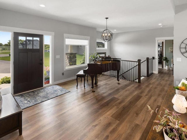 foyer featuring dark wood-type flooring and a notable chandelier