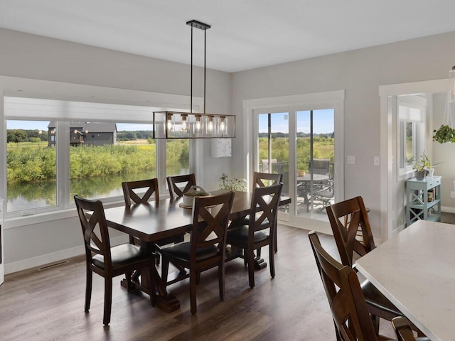 dining area featuring a notable chandelier and dark hardwood / wood-style flooring