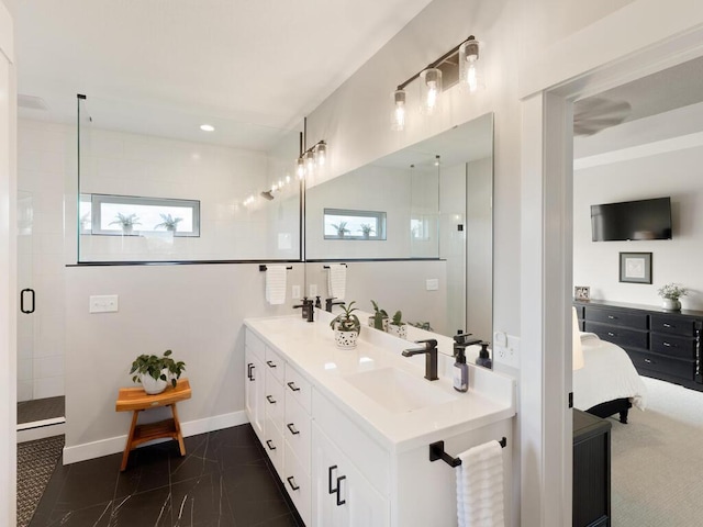 bathroom featuring a tile shower and vanity