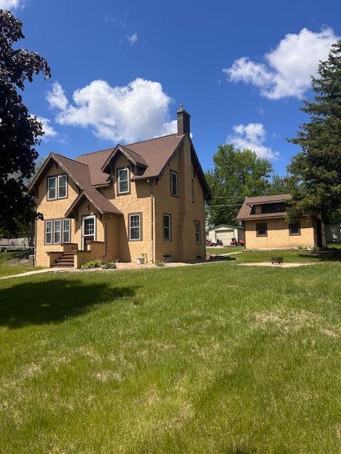 310 7th St, Starbuck, MN 56381 - view of front of property with a chimney and a front lawn