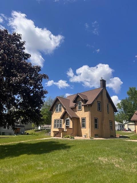 310 7th St, Starbuck, MN 56381 - traditional-style home featuring a chimney, a front yard, and stucco siding