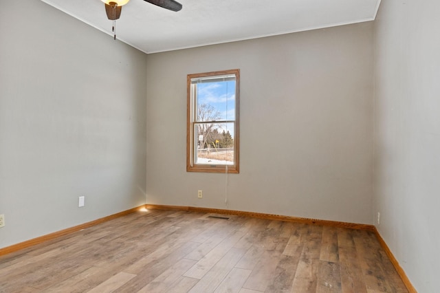 empty room with ceiling fan and light wood-type flooring