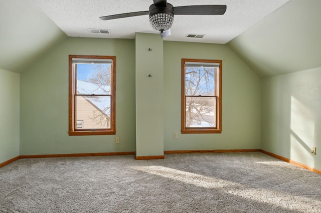 additional living space with ceiling fan, carpet flooring, a textured ceiling, and lofted ceiling