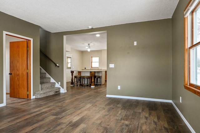 spare room with dark wood-type flooring and a textured ceiling