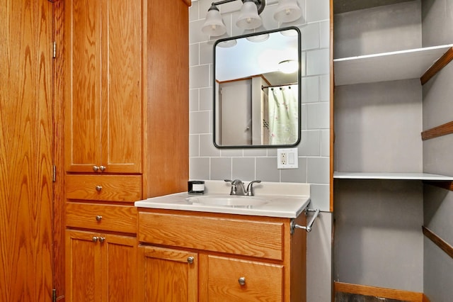 bathroom with vanity and tasteful backsplash