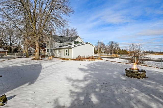 view of snow covered exterior featuring a fire pit