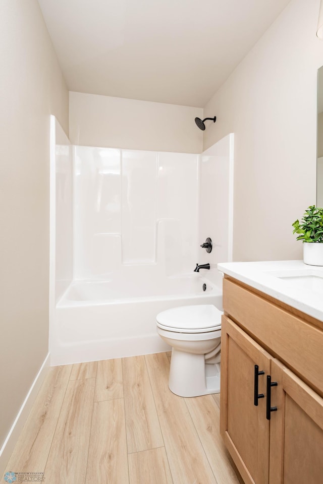 131 Pine Ave, Mapleton, ND 58059 - bathroom with wood finished floors, vanity, toilet, and bathing tub / shower combination