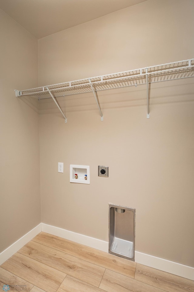 131 Pine Ave, Mapleton, ND 58059 - washroom with hookup for an electric dryer, light wood-style flooring, and baseboards