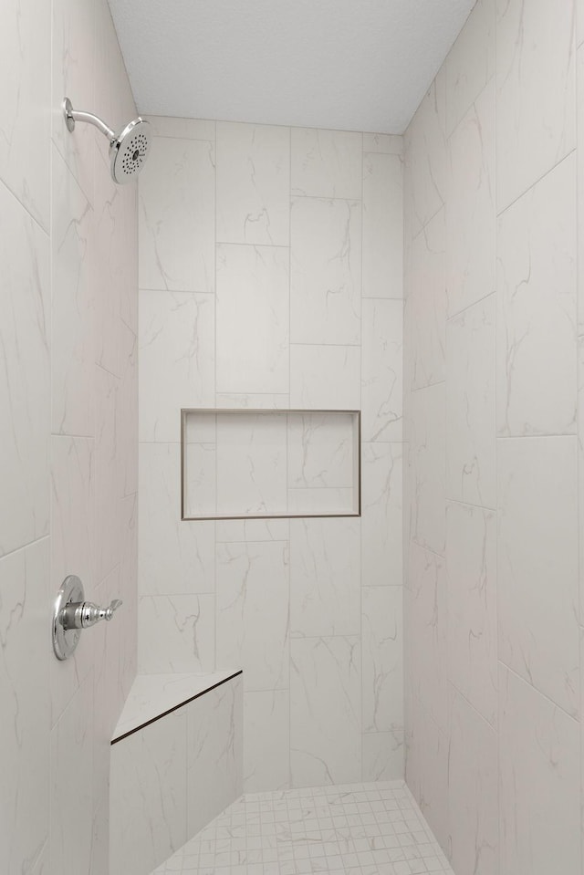 bathroom with tiled shower