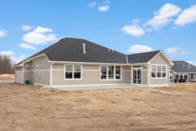 back of property with central air condition unit and a patio area