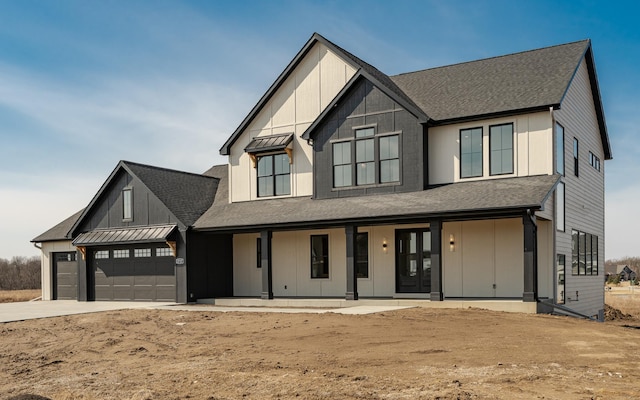 modern farmhouse with roof with shingles, a porch, an attached garage, concrete driveway, and board and batten siding