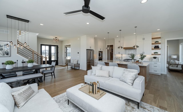 living room featuring recessed lighting, visible vents, light wood-style flooring, and a ceiling fan