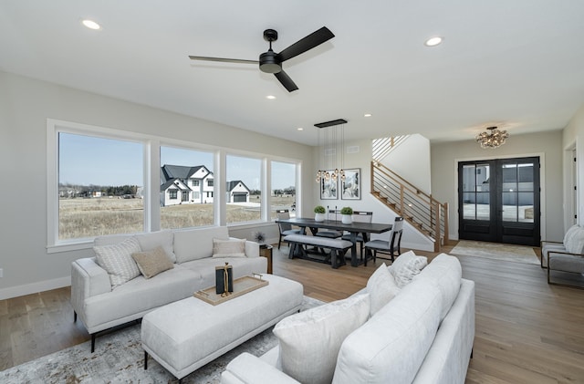 living area featuring stairway, recessed lighting, wood finished floors, and a wealth of natural light