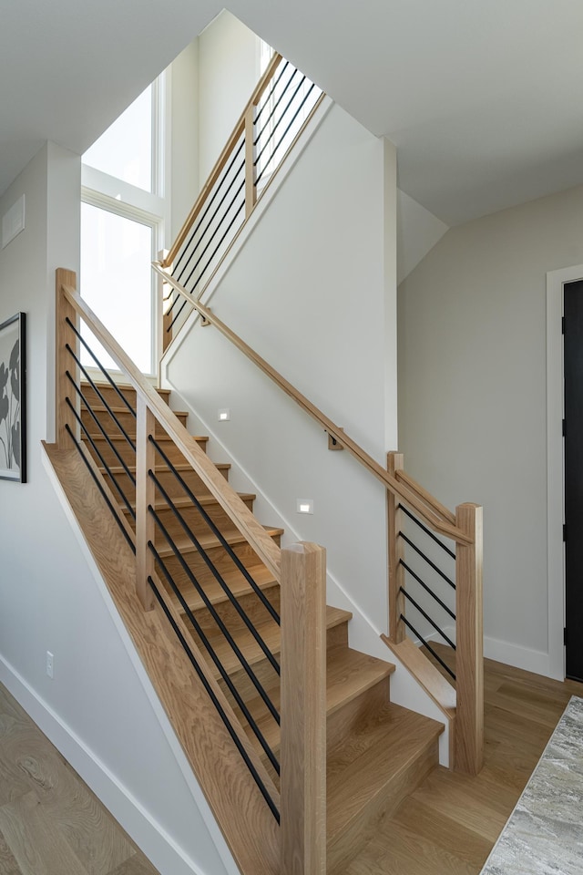 stairs featuring baseboards and wood finished floors