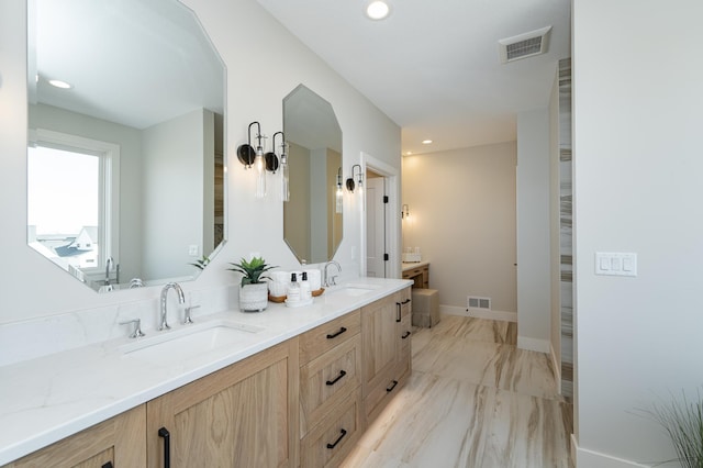 bathroom featuring a sink, visible vents, and double vanity