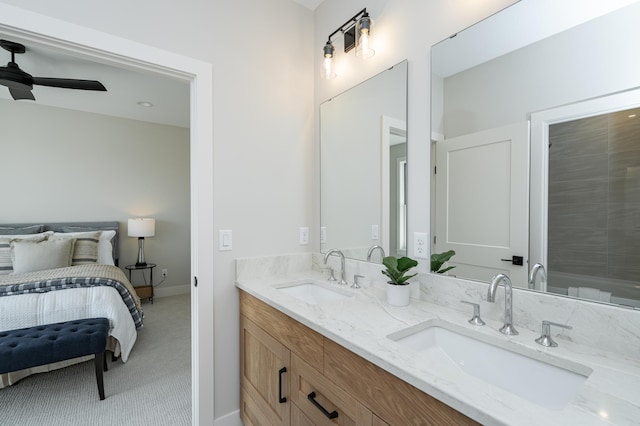 bathroom with double vanity, a ceiling fan, baseboards, and a sink