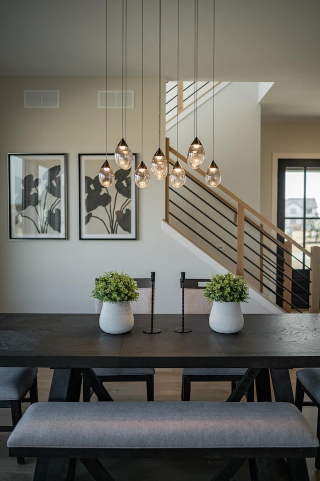 dining area featuring visible vents and stairway