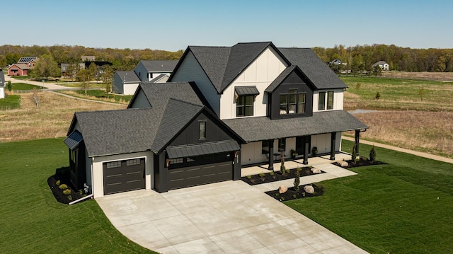 2727 Mayo Prairie Ln SW, Rochester Twp, MN 55902 - modern farmhouse style home with board and batten siding, a porch, a front lawn, concrete driveway, and roof with shingles