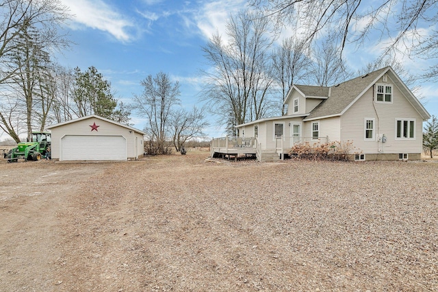 view of side of home featuring a garage and a deck