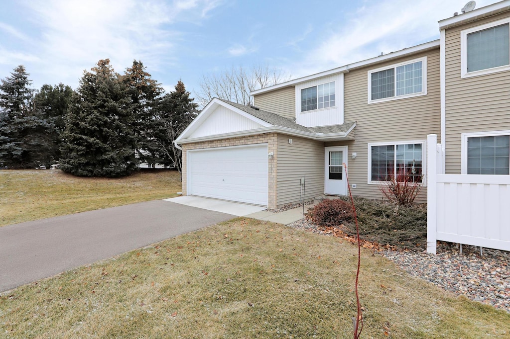 view of front of home with a front lawn and a garage