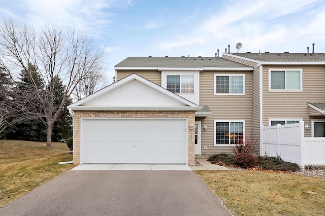 view of front of property featuring a front yard and a garage