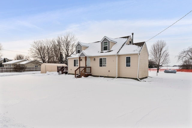 view of snow covered back of property