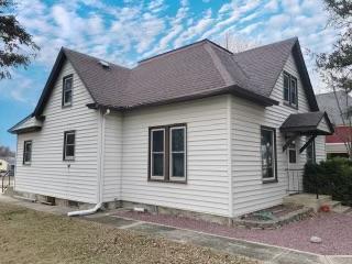 view of side of property with a yard