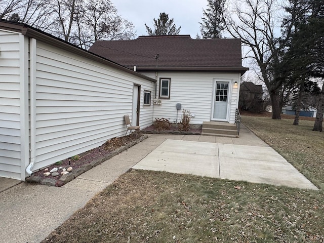 rear view of house with a patio area and a lawn