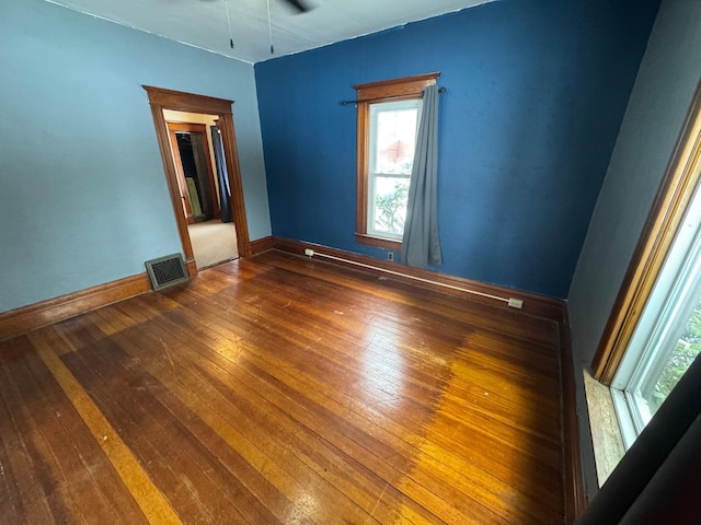 spare room with dark hardwood / wood-style floors