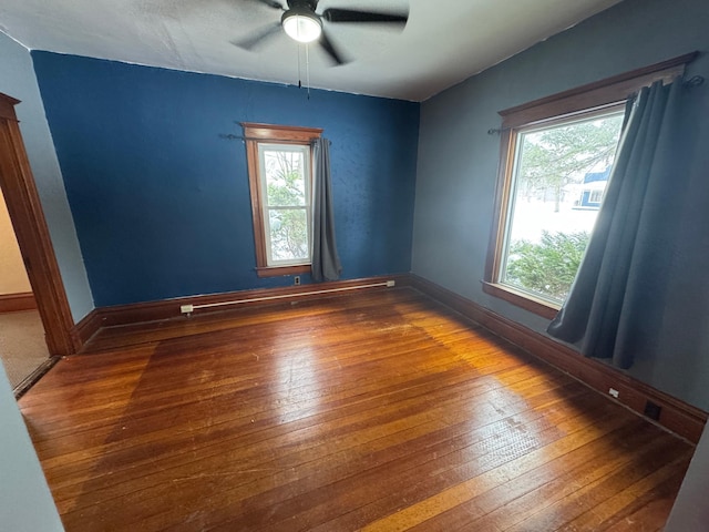 unfurnished room with hardwood / wood-style flooring and ceiling fan