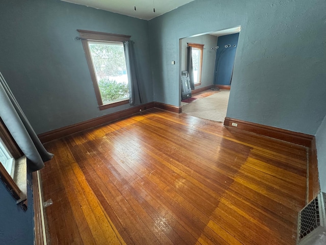 unfurnished room with wood-type flooring