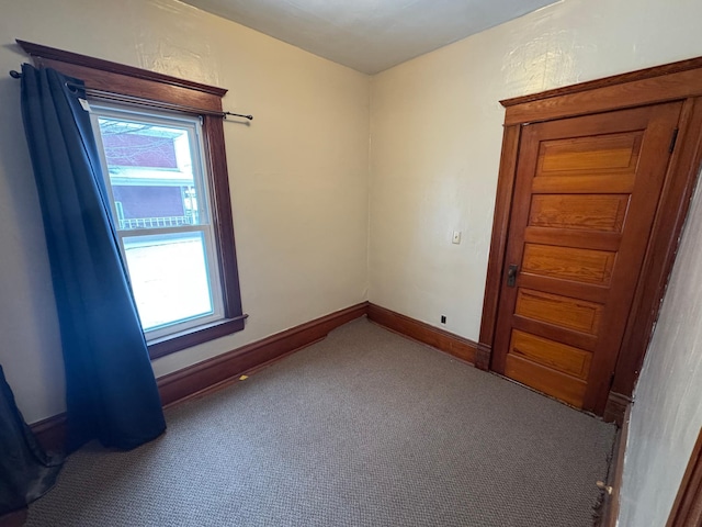 carpeted empty room featuring a wealth of natural light