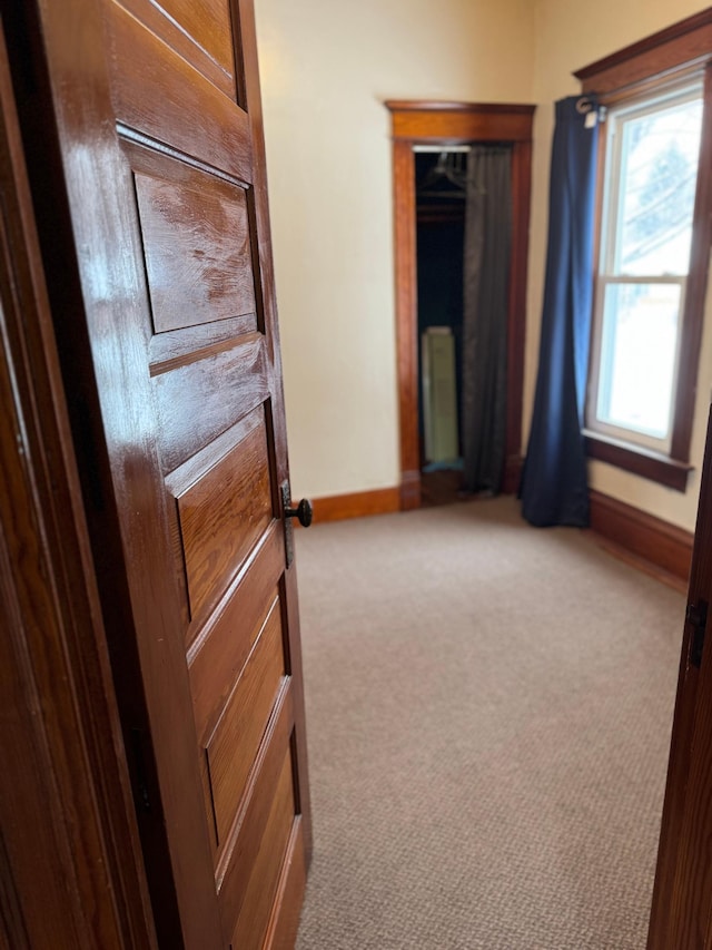 carpeted empty room featuring radiator heating unit