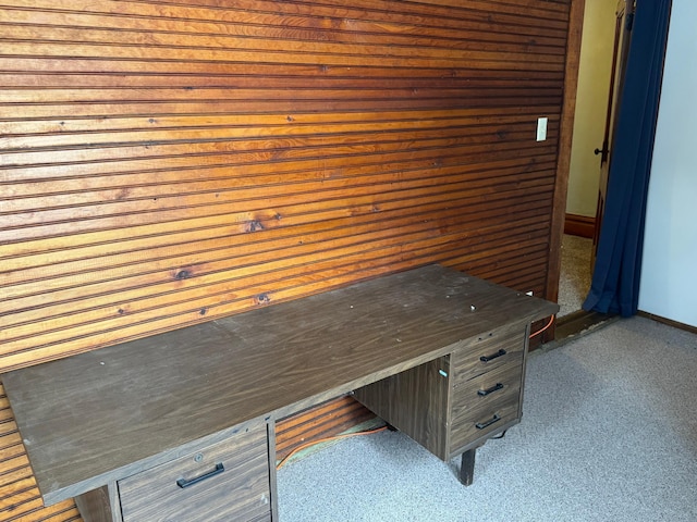 unfurnished office with dark colored carpet and wood walls