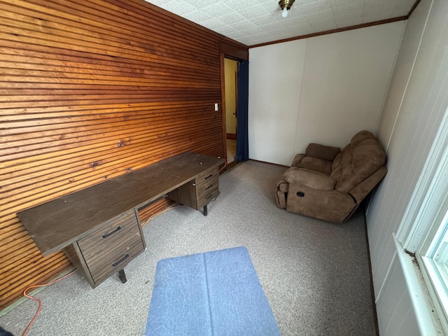 home office featuring crown molding and wood walls