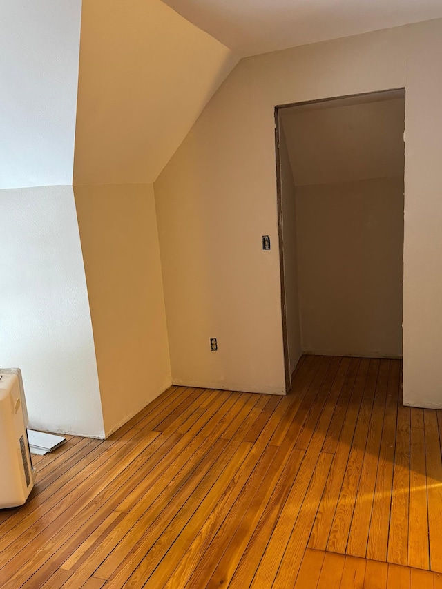 additional living space featuring light hardwood / wood-style floors and lofted ceiling