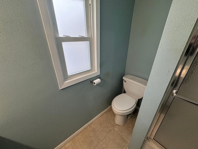 bathroom with tile patterned flooring and toilet