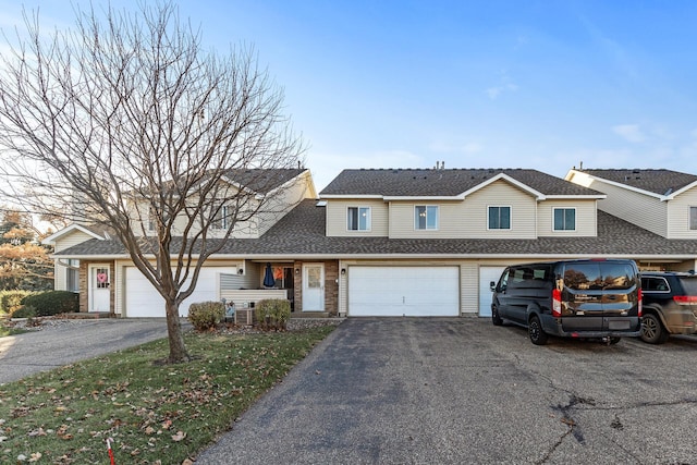 view of front of home featuring central AC unit and a garage