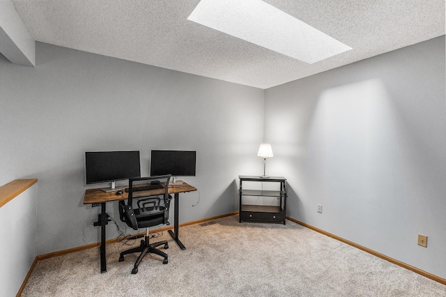 carpeted home office featuring a textured ceiling