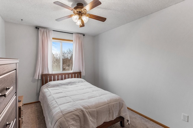 carpeted bedroom with ceiling fan and a textured ceiling