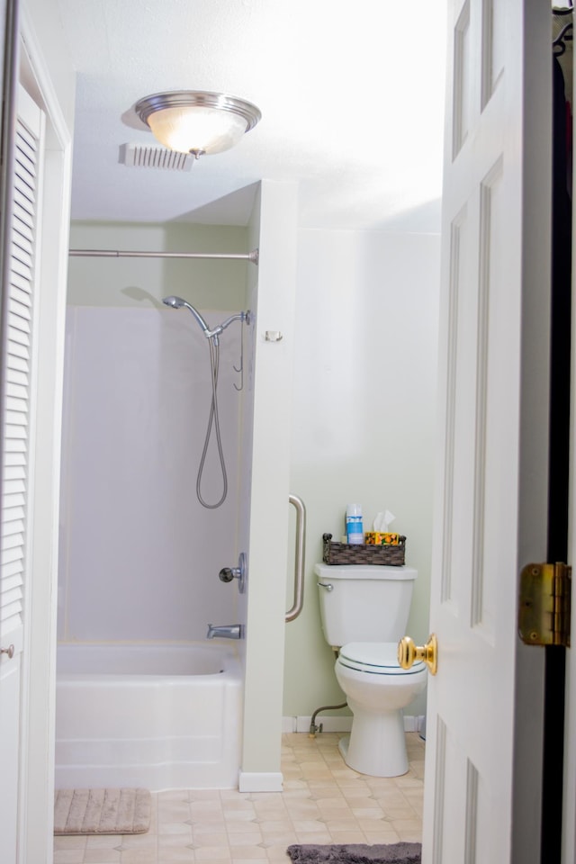 bathroom featuring tile patterned flooring, shower / bathtub combination, and toilet