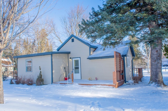 view of snow covered rear of property