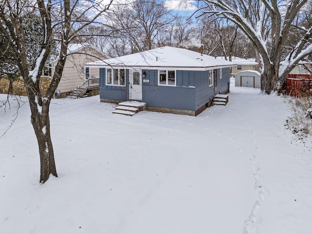 view of front of property with a shed