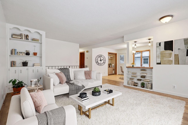 living room featuring light hardwood / wood-style floors and a textured ceiling