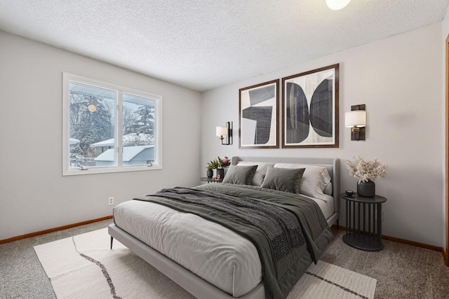 bedroom with a textured ceiling and carpet