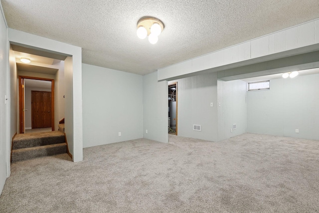 basement with a textured ceiling and carpet flooring