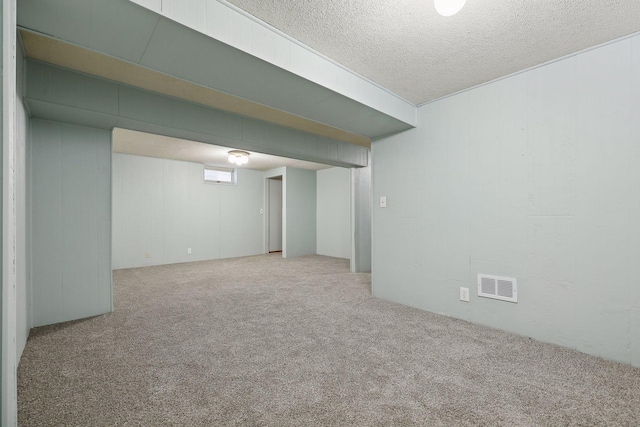 basement with a textured ceiling and carpet floors